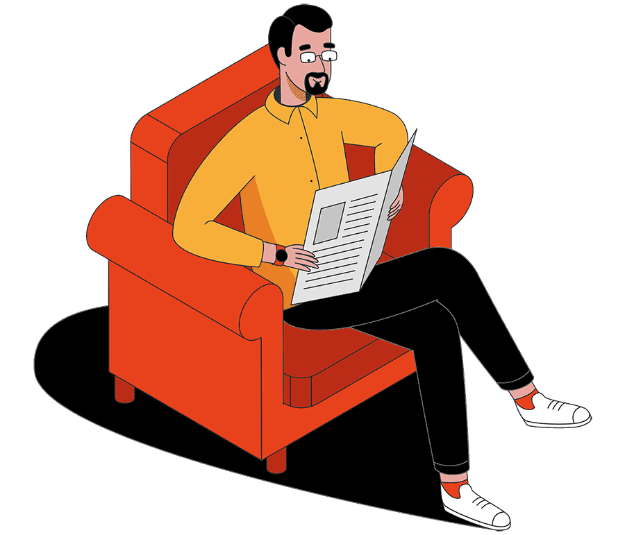 Adam sitting in a chair reading a newspaper